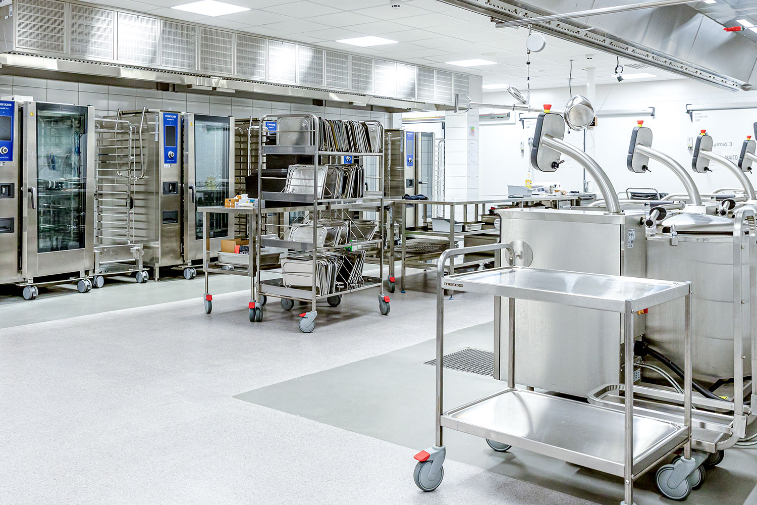 Service technician maintaining professional kitchen equipment